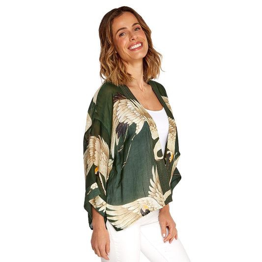 The Heron Print Forest Green Short Kimono features a vibrant heron design and offers a relaxed fit. Available in sizes S, M, L, XL.