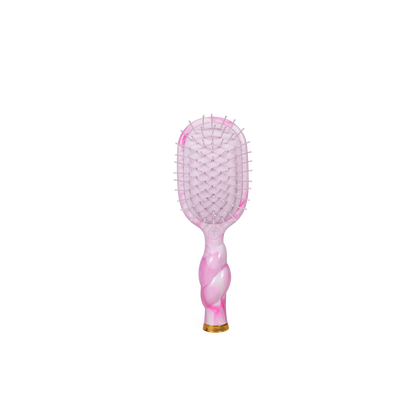 Mini Detangler Brush in “Pinch Me!” colorway with a pink rectangular head, twisted marbled handle, and gold detailing at the base. Available in mini size.