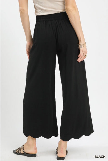 Black Scallop Wide Leg Pants with scalloped hem and elastic waistband. Available in sizes XS–XL.