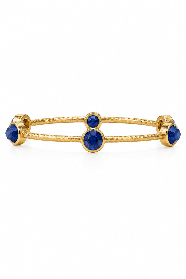 Milano Luxe Bangle: hammered 24K gold-plated, textured bangle with five round, faceted iridescent gemstones. Available in multiple sizes.
