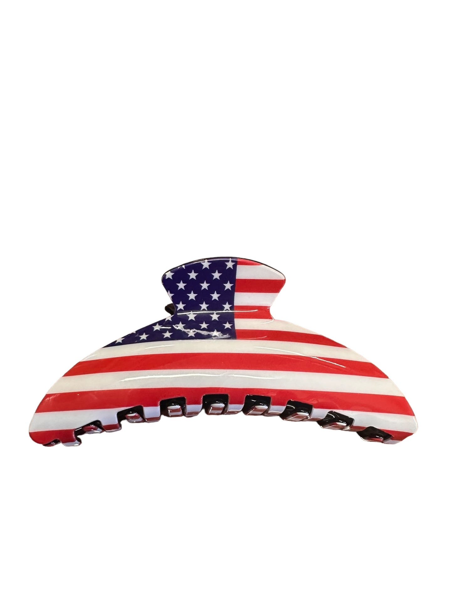 Hair claw clip with American flag design: red and white stripes, white stars on blue. 