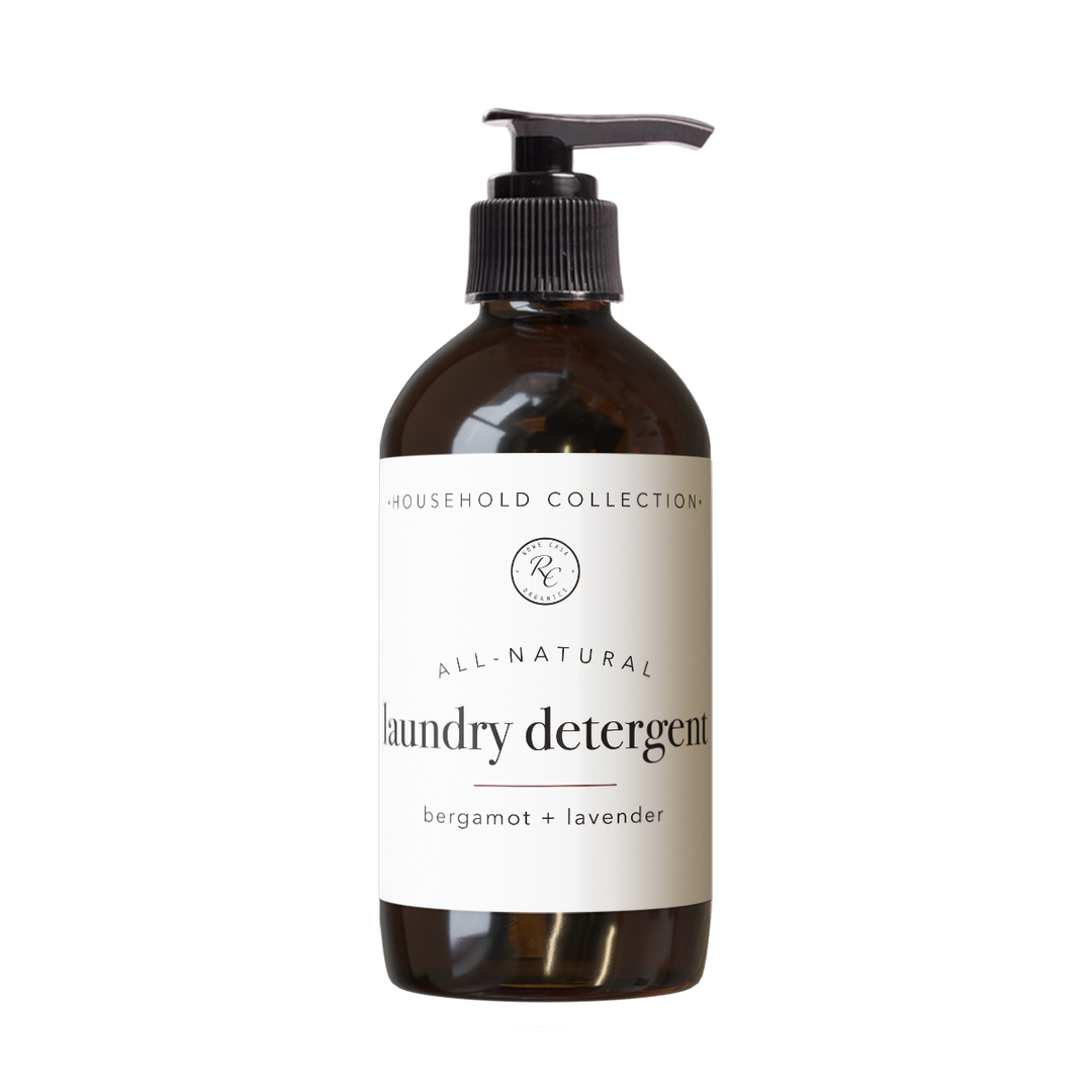 Brown pump bottle labeled “LAUNDRY DETERGENT | LIQUID | 16 oz: BERGAMOT + LAVENDER.” Available in 16 oz size. Non-toxic formula for gentle, effective cleaning.