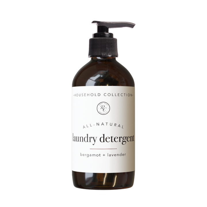 Brown pump bottle labeled “LAUNDRY DETERGENT | LIQUID | 16 oz: BERGAMOT + LAVENDER.” Available in 16 oz size. Non-toxic formula for gentle, effective cleaning.