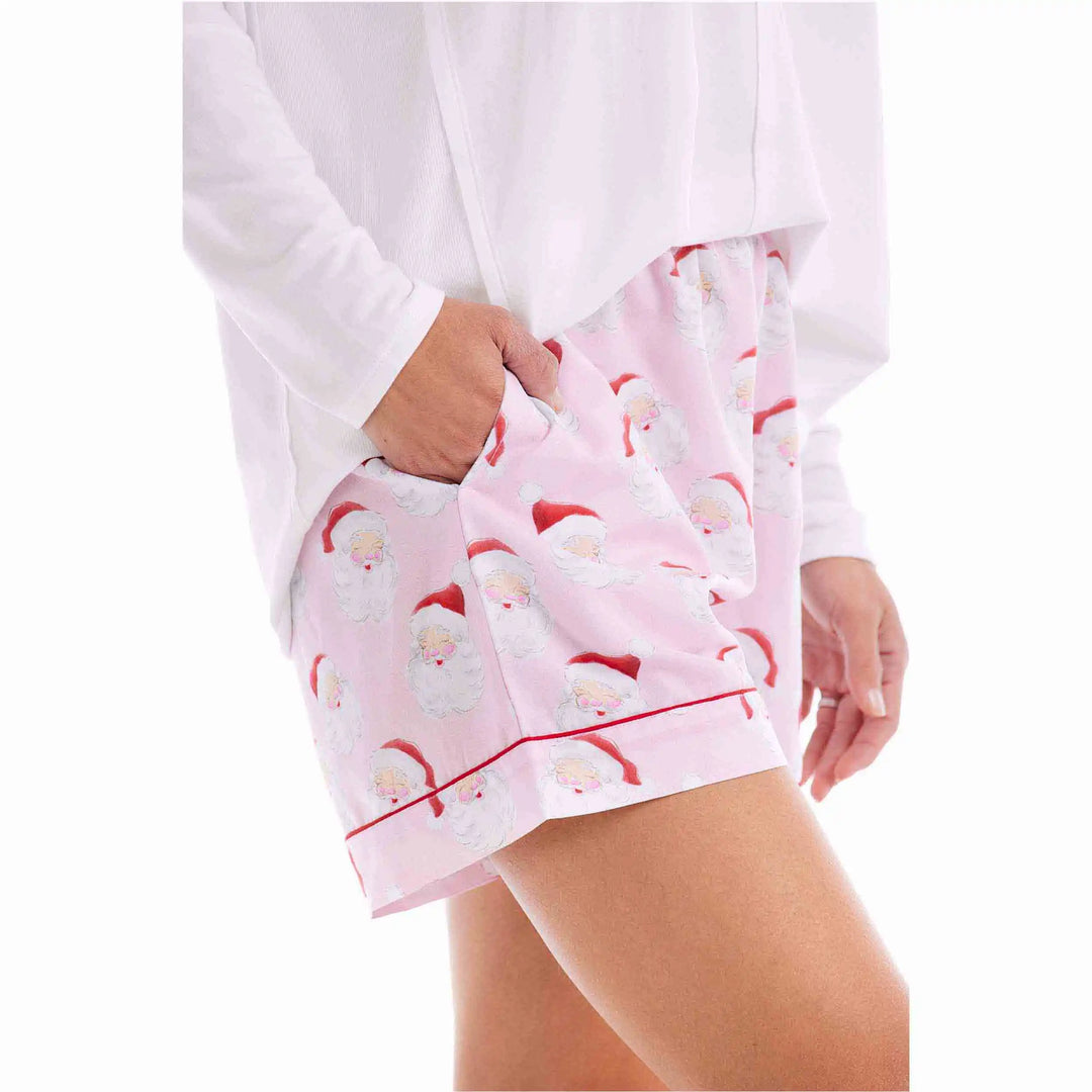 Light pink Santa holiday sleep shorts with a repeating Santa Claus face pattern and red piped trim. Available in all sizes.