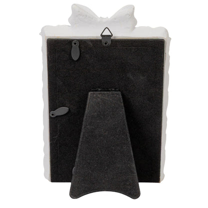 Plastic photo frame with bow, antique white edge, black stand, swivel tabs, metal hook. Fits 4x6 photos.