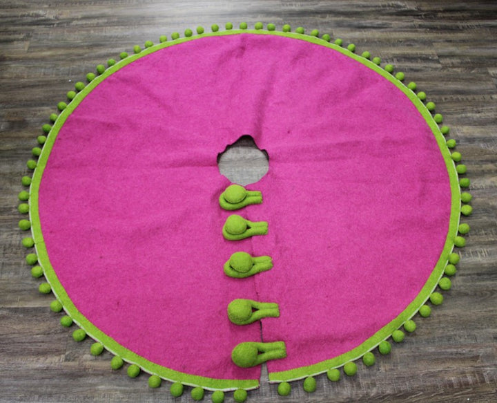 Handmade round pink wool tree skirt with lime green border, pom-pom trim, and five lime green toggles.
