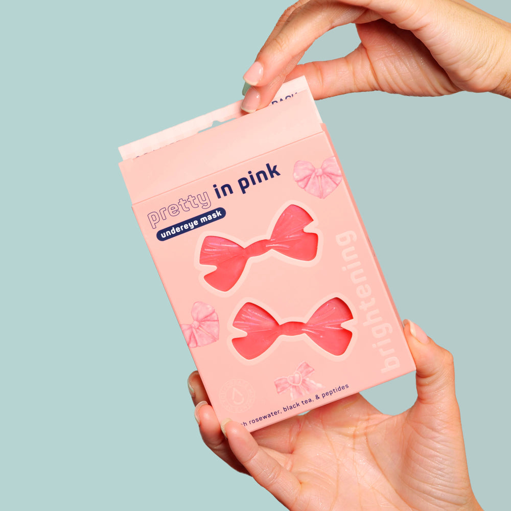 Pretty in Pink! Brightening Undereye Masks, Pack of 8. Bow-shaped, rosewater-infused masks visible through clear window.