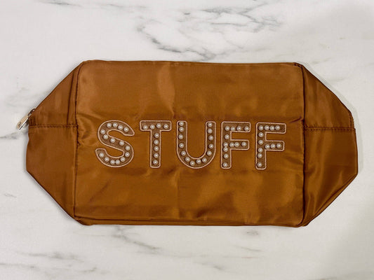 Stuff Nylon Bag Pouch - Cognac

- Sewn-on pearl varsity letter initials: "STUFF" 
- Bold stylized letters with white circles
- Shiny gold zipper 
- Sizes available: Extra Large