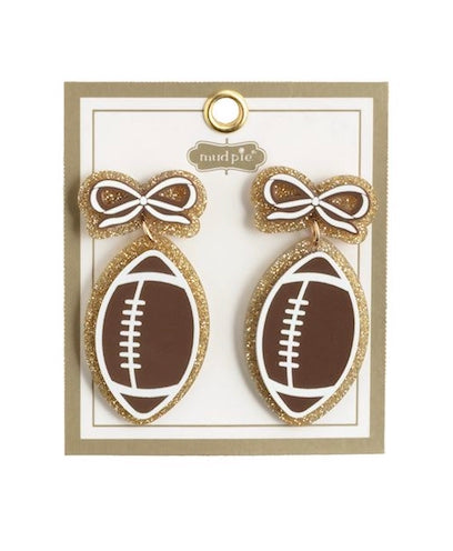 Football-shaped earrings with gold glitter borders and a sparkling gold glitter bow. Available in 3 styles. Sizes available: not specified.