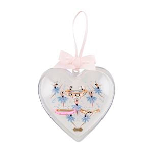 Clear heart ornament with pink ribbon, holding pastel hair clips and enamel rings. Available in sizes 5-8.