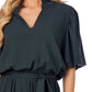 Annalise Jumpsuit in dark green with ruffle collar, v-neckline, short sleeves, removable waist tie. Available in sizes XS-XL.