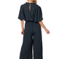 Annalise Jumpsuit—dark green polyester, wide legs, keyhole back, removable waist tie. Available in sizes XS–XL.