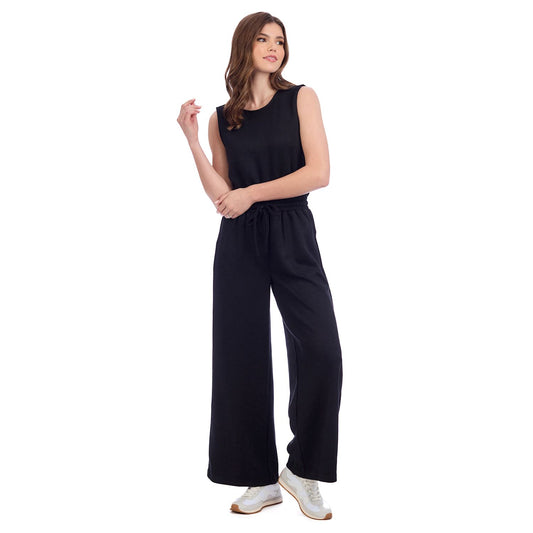 Atlas Jumpsuit: sleeveless black scuba knit, wide-leg pants. Available in sizes XS–XL.