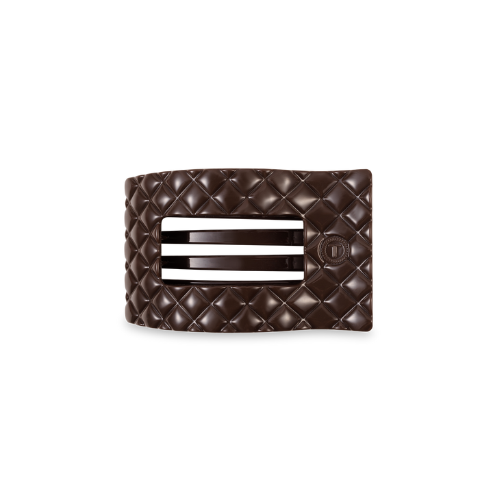 Dark brown TELETIES Flat Rectangle Hair Clip with quilted pattern, two horizontal slits, circular emblem; available in multiple sizes.