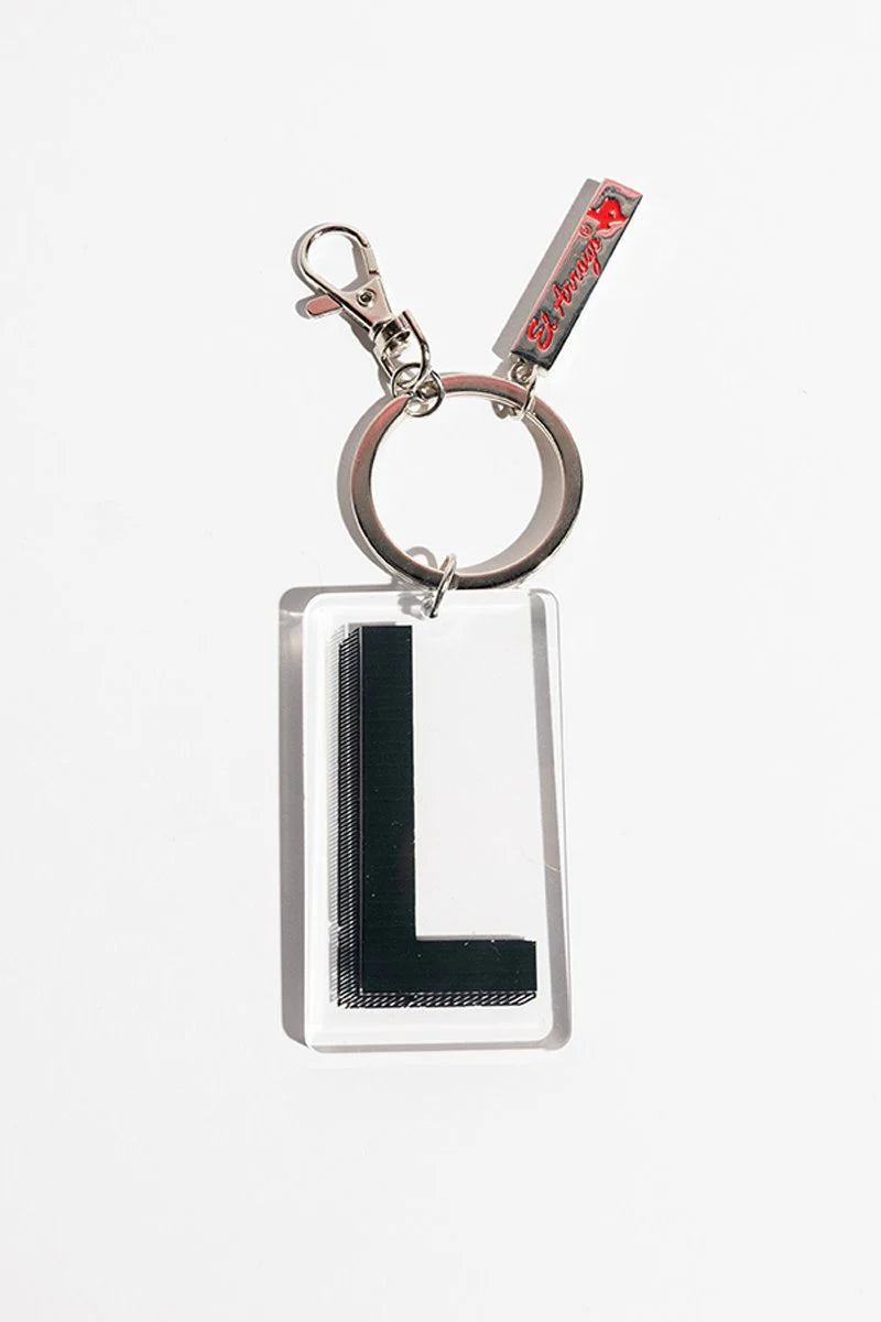 Clear rectangular keychain with bold black "L," metal ring, clip, and red tag accent. Available in one size.
