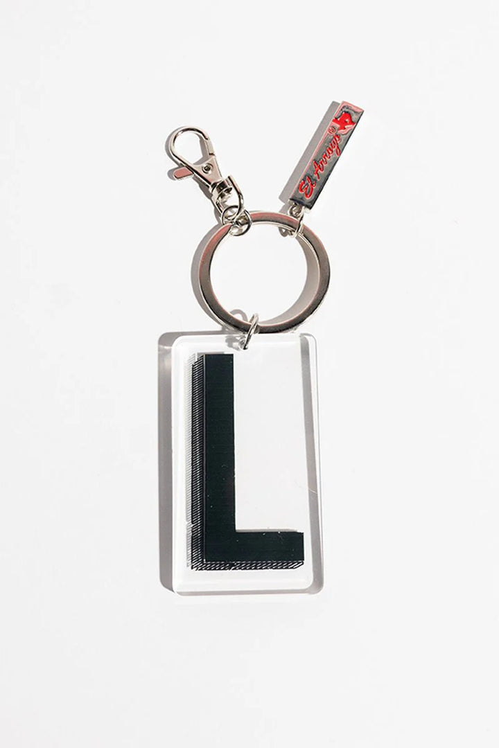 Clear rectangular keychain with bold black "L," metal ring, clip, and red tag accent. Available in one size.