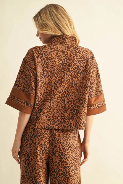 Leopard Zip-Up Top with brown and black leopard pattern on a light background. Available in sizes XS–XL.