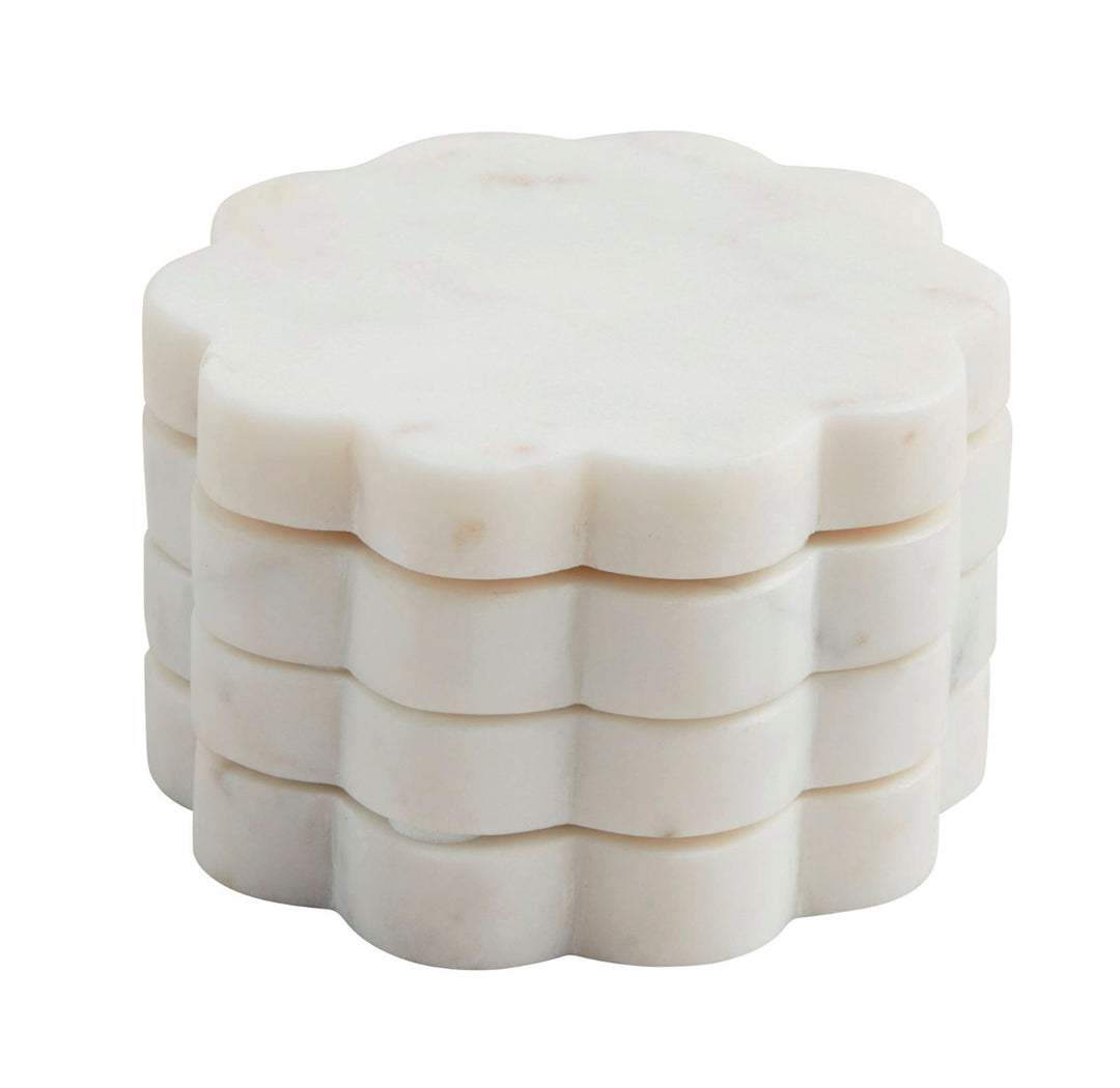Set of four white marble beaded coasters with scalloped edges, each 4-inch diameter.