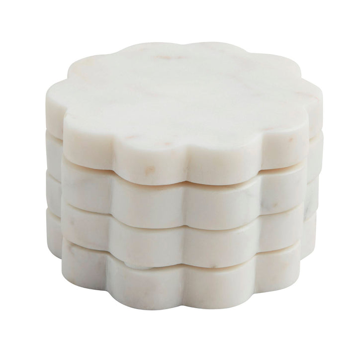 Set of four white marble beaded coasters with scalloped edges, each 4-inch diameter.