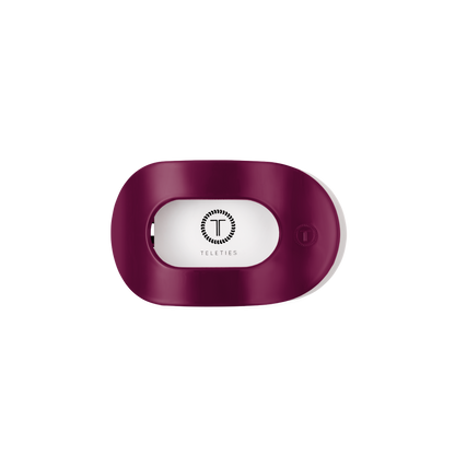 Maroon, oval-shaped plastic hair tie holder with open slot and TELETIES logo in black; available in multiple sizes.