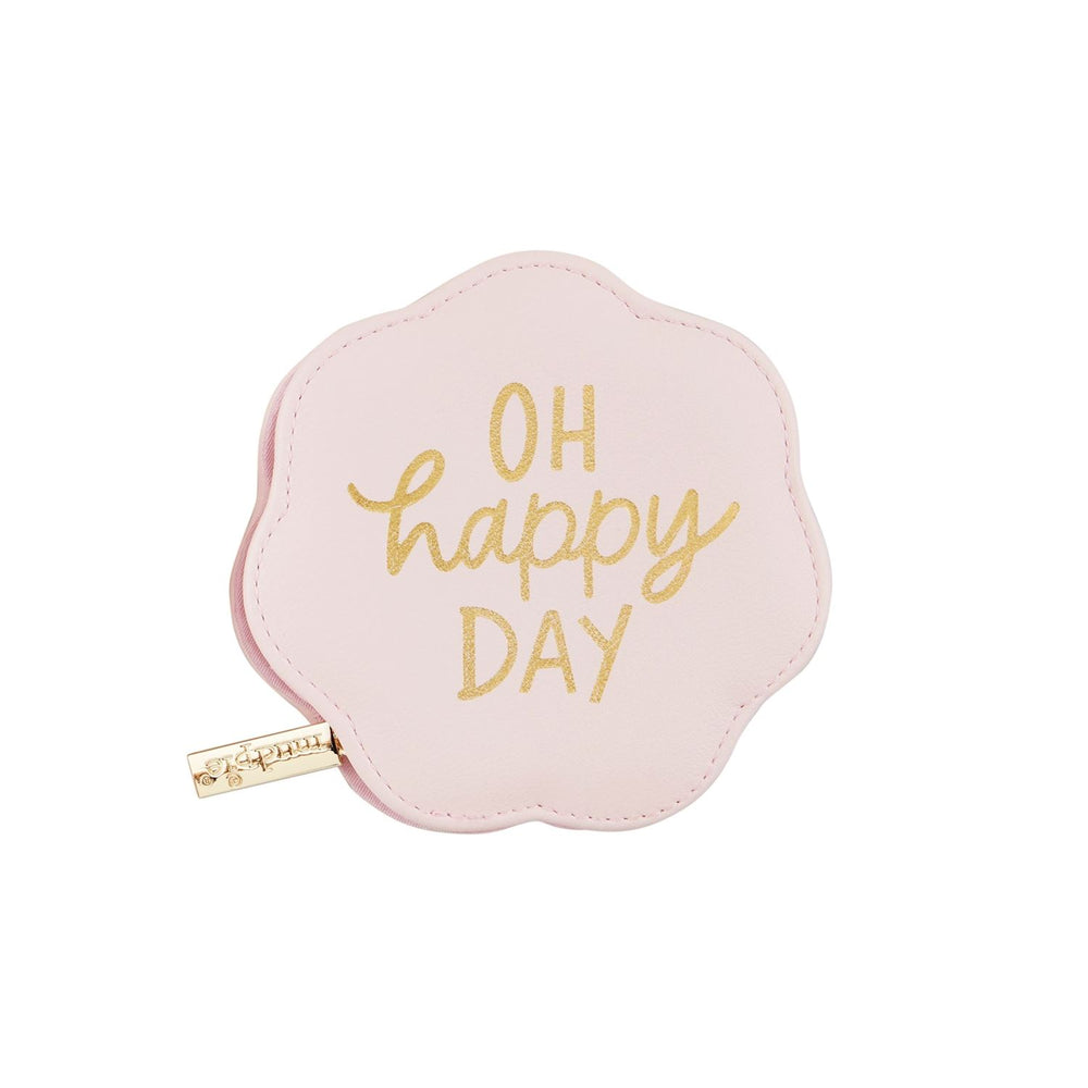The Pink Shaped Pill Cases are flower-shaped pouches in pink foiled faux leather, featuring "Oh happy day" in gold lettering. They have a divided plastic interior and a zipper closure, with a small gold tag on the side. Available sizes: Small.