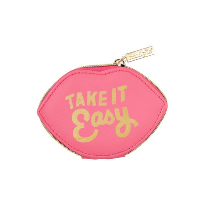 Pink Shaped Pill Case designed like lips with "Take It Easy" gold text. Features a divided plastic interior and foiled faux leather exterior. Includes a gold zipper pull with brand tag. Size: 3.5" x 2" x 1".
