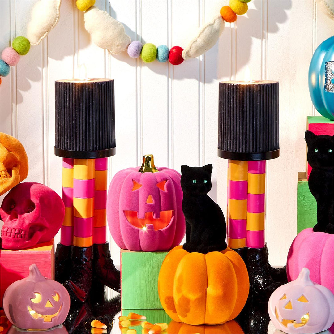 Bewitching Pillar Candleholder with Glitter Accent available in multiple sizes; features vibrant Halloween colors.