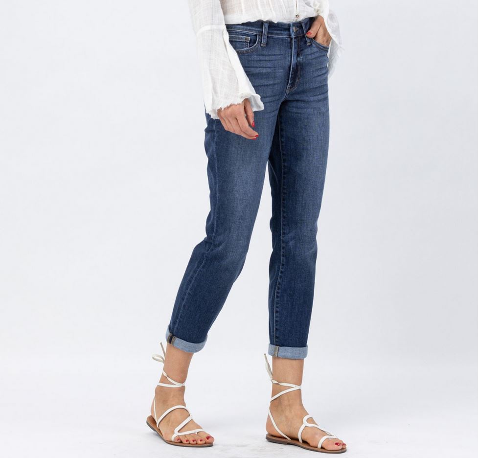 White long-sleeve top with flared cuffs. Available sizes: S, M, L.  
Dark blue Judy Blue Midrise Cuffed Boyfriend Jeans. Available sizes: 24-32.  
White strappy sandals. Available sizes: 5-11 US women’s.