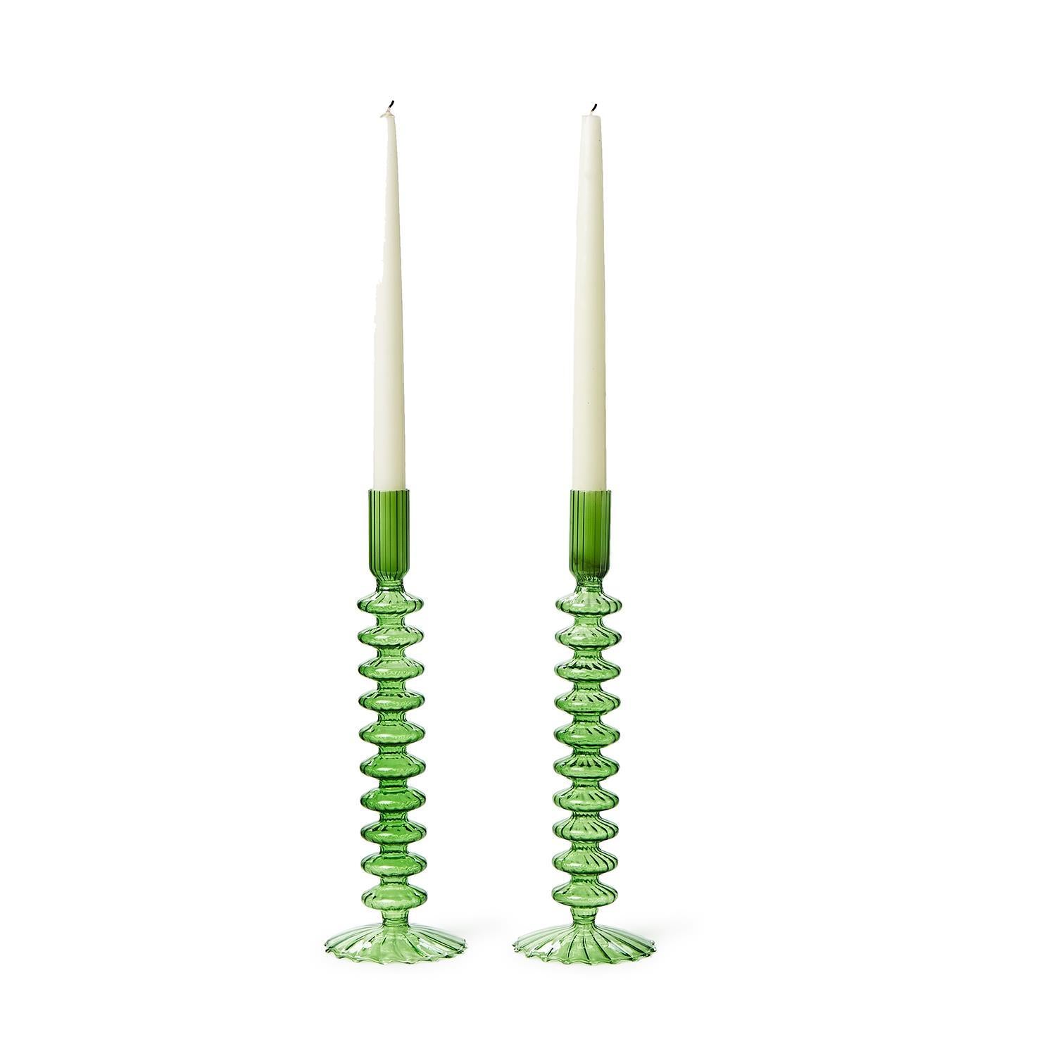 Tall, green hand-blown glass candlesticks with intricate ribbed designs. Flared bases for modern elegance. Size: One size.