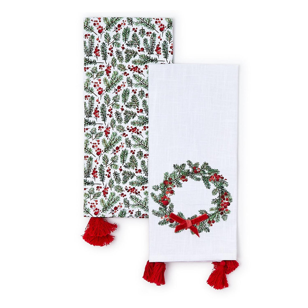 Merry Berry set of 2 dish towels featuring one pine and berry pattern towel and one wreath and red velvet bow towel, both with red tassels.