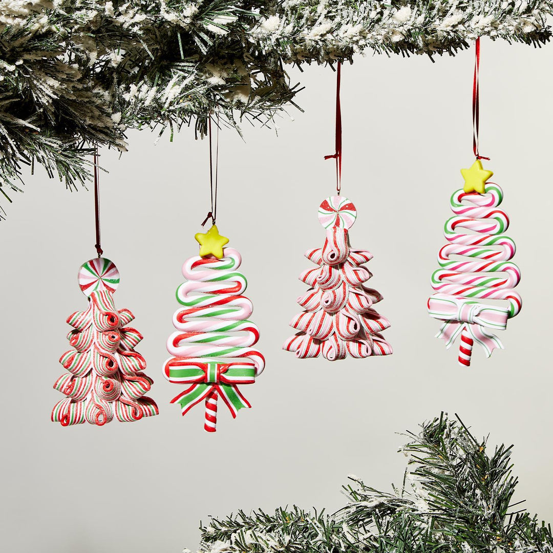 Four hand-crafted gingerbread ornaments shaped like festive trees. Features red, green, and white candy patterns with a yellow star and ribbon bows. Size: not specified.