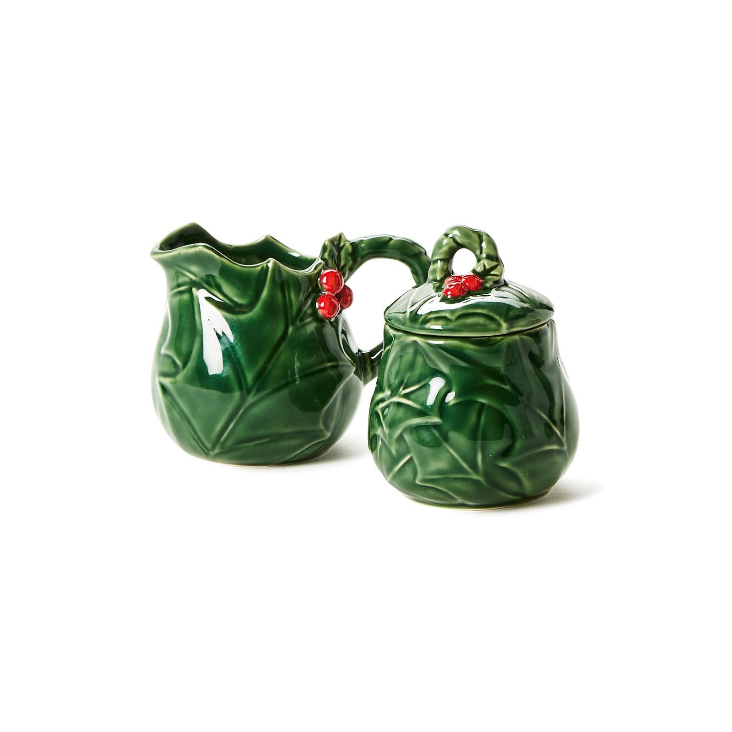 Holiday Holly Creamer and Sugar Set: Stoneware, dark green with embossed holly leaf design and red berry accents. Sizes: Creamer and sugar bowl included.