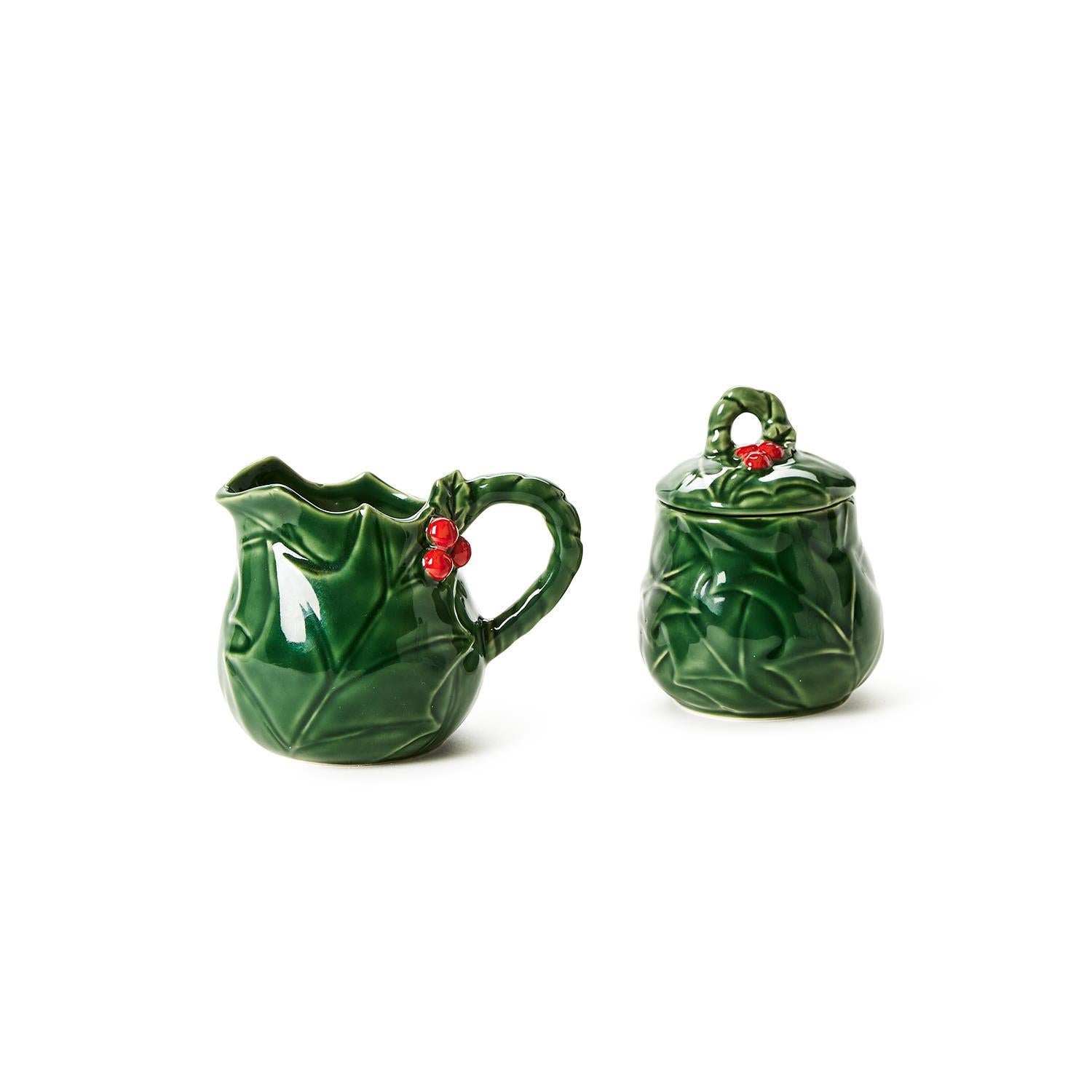 Holiday Holly Creamer and Sugar Set: Green porcelain with embossed holly leaf design and red berry accents. Includes creamer with spout and sugar bowl with lid. Available sizes: One size set.