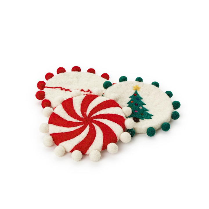 Set of 4 hand-crafted felt coasters with pom-pom trim, featuring peppermint swirls, a Christmas tree, and embroidery.