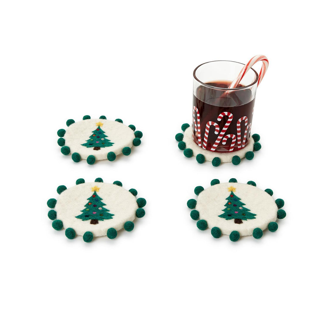 Set of 4 hand-crafted round white felt coasters with dark green pom-pom edges and green Christmas tree designs. Sizes available: standard.