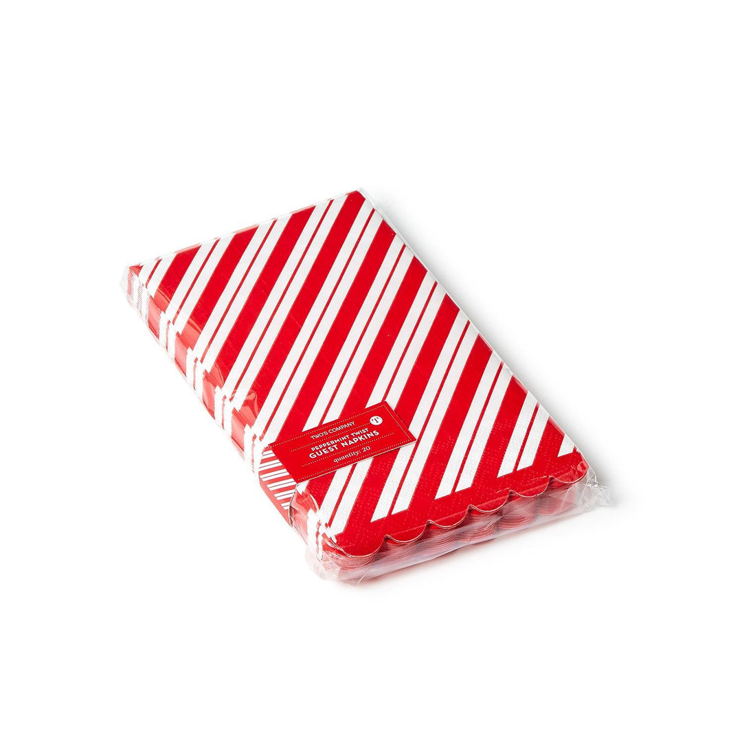 Package of rectangular Peppermint Twist 3-ply paper dinner napkins/guest towels with scalloped edges and red and white diagonal candy cane stripes.