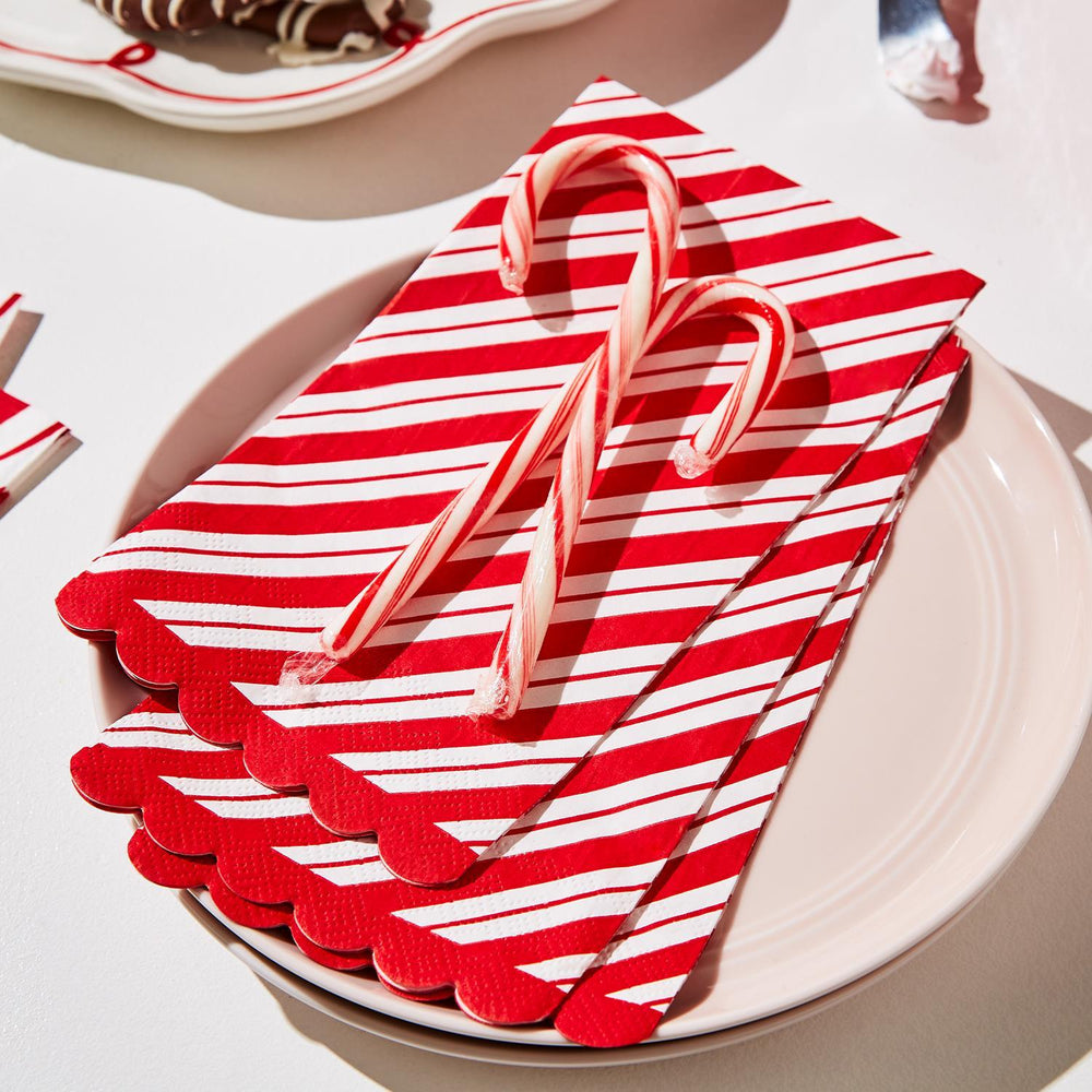 Peppermint Twist 3-Ply Paper Dinner Napkin/Guest Towel with Scalloped Edge featuring red and white stripes.