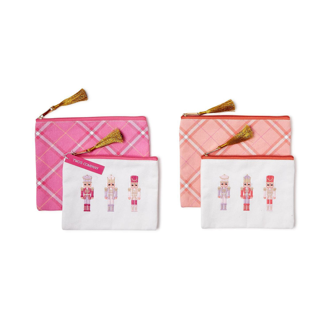 Two sets of Nutcracker Pink Sugar Multipurpose Pouches with Tassels, featuring pink plaid and white nutcracker-embroidered pouches with gold tassels.