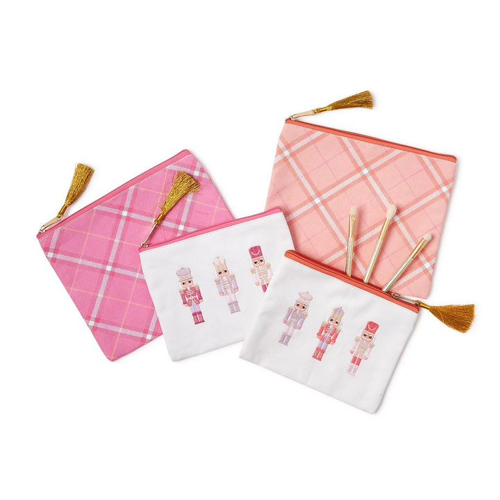 Four Nutcracker Pink Sugar multipurpose pouches in pink plaid or nutcracker prints with gold tassels.