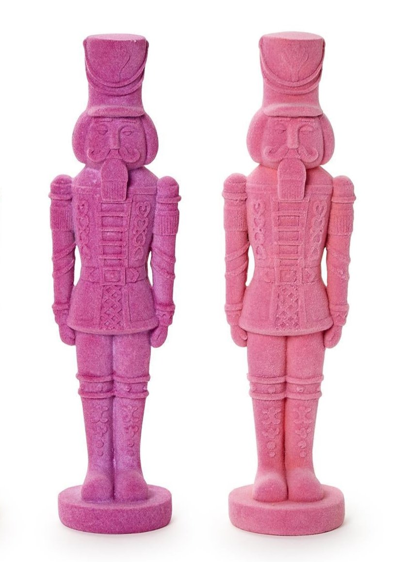 A duo of Flocked Nutcrackers in purple and pink with detailed features, uniforms, and tall hats. One size.