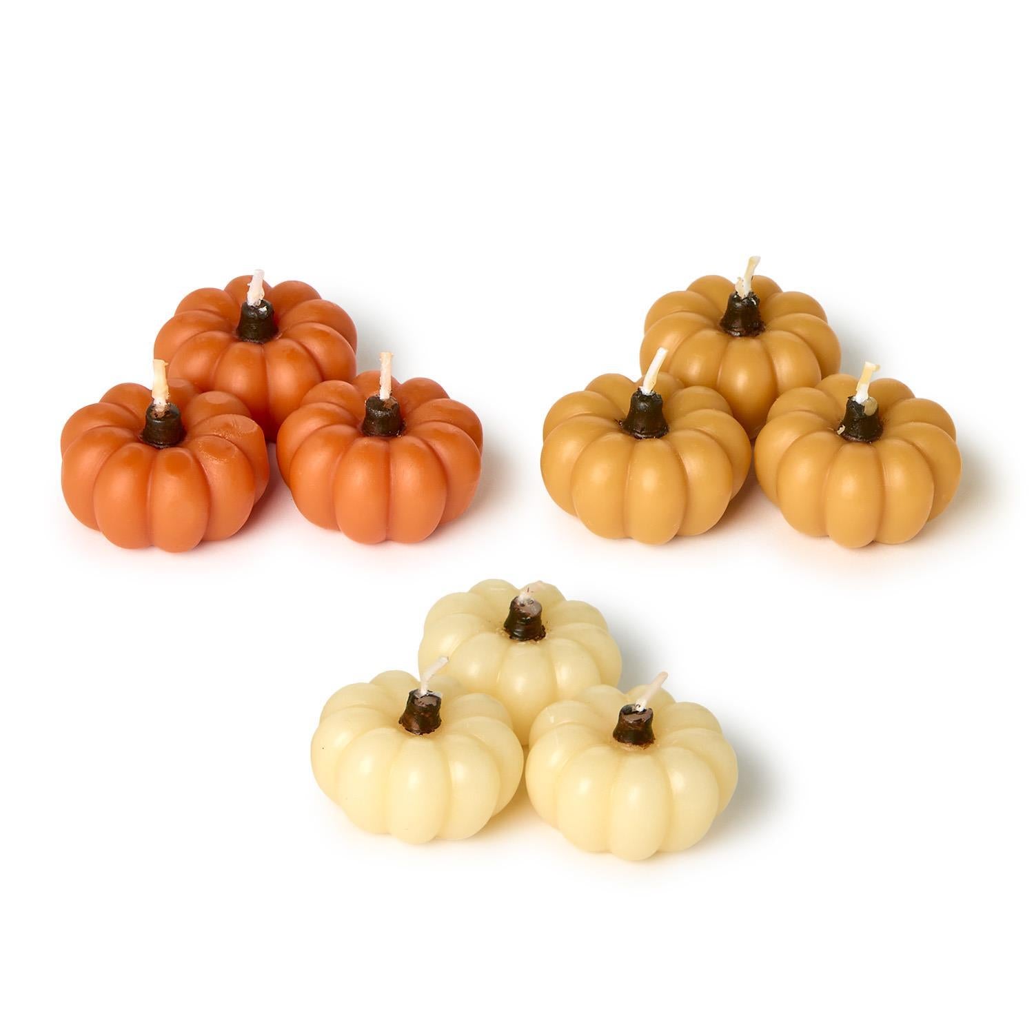 Mini Pumpkin Candles in Gift Box: nine clustered candles in orange, tan, and cream. Available sizes: mini.