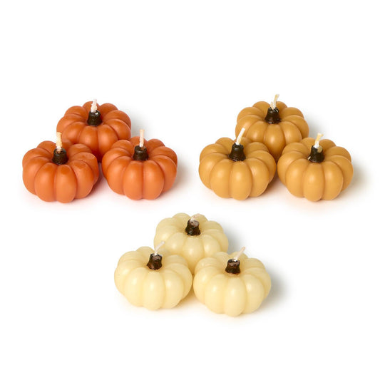Mini Pumpkin Candles in Gift Box: nine clustered candles in orange, tan, and cream. Available sizes: mini.