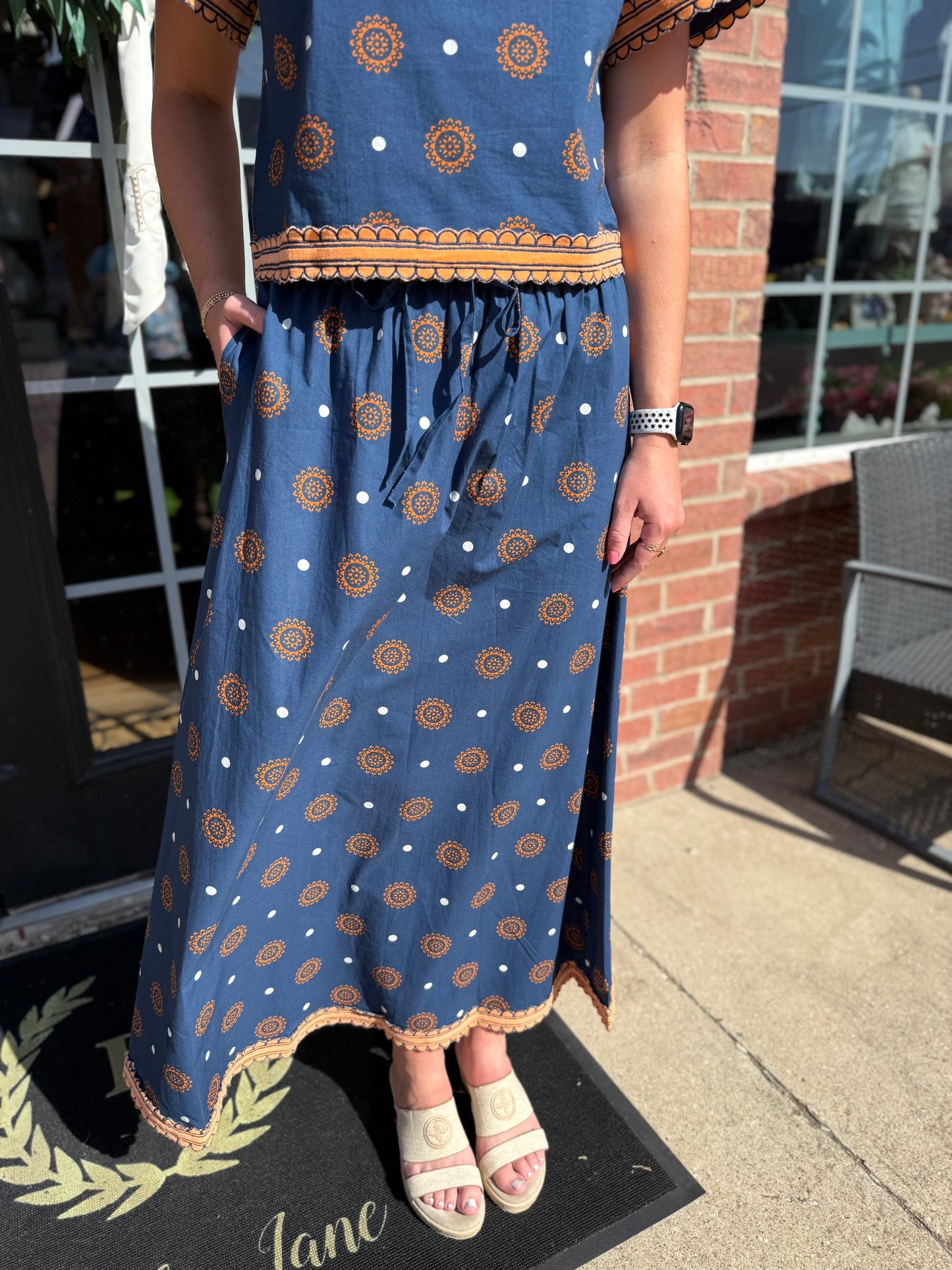 Auburn Medallion Skirt Set: blue dress with orange patterns and white dots, available in sizes XS-XL.