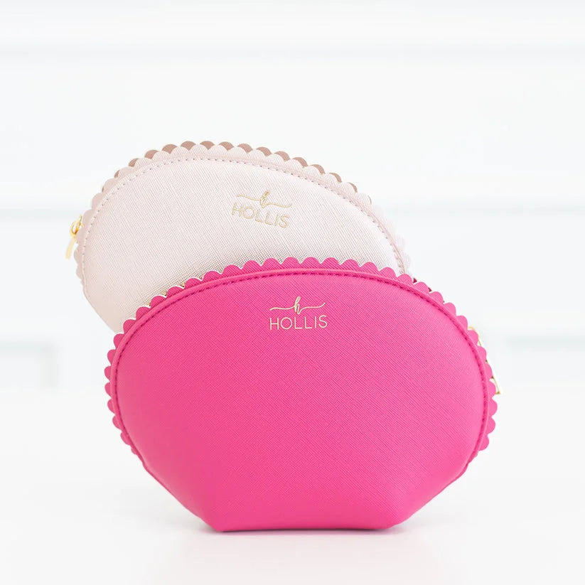 Bright pink and light beige mini travel bags with gold zippers and "HOLLIS" in gold. Set includes multiple sizes.