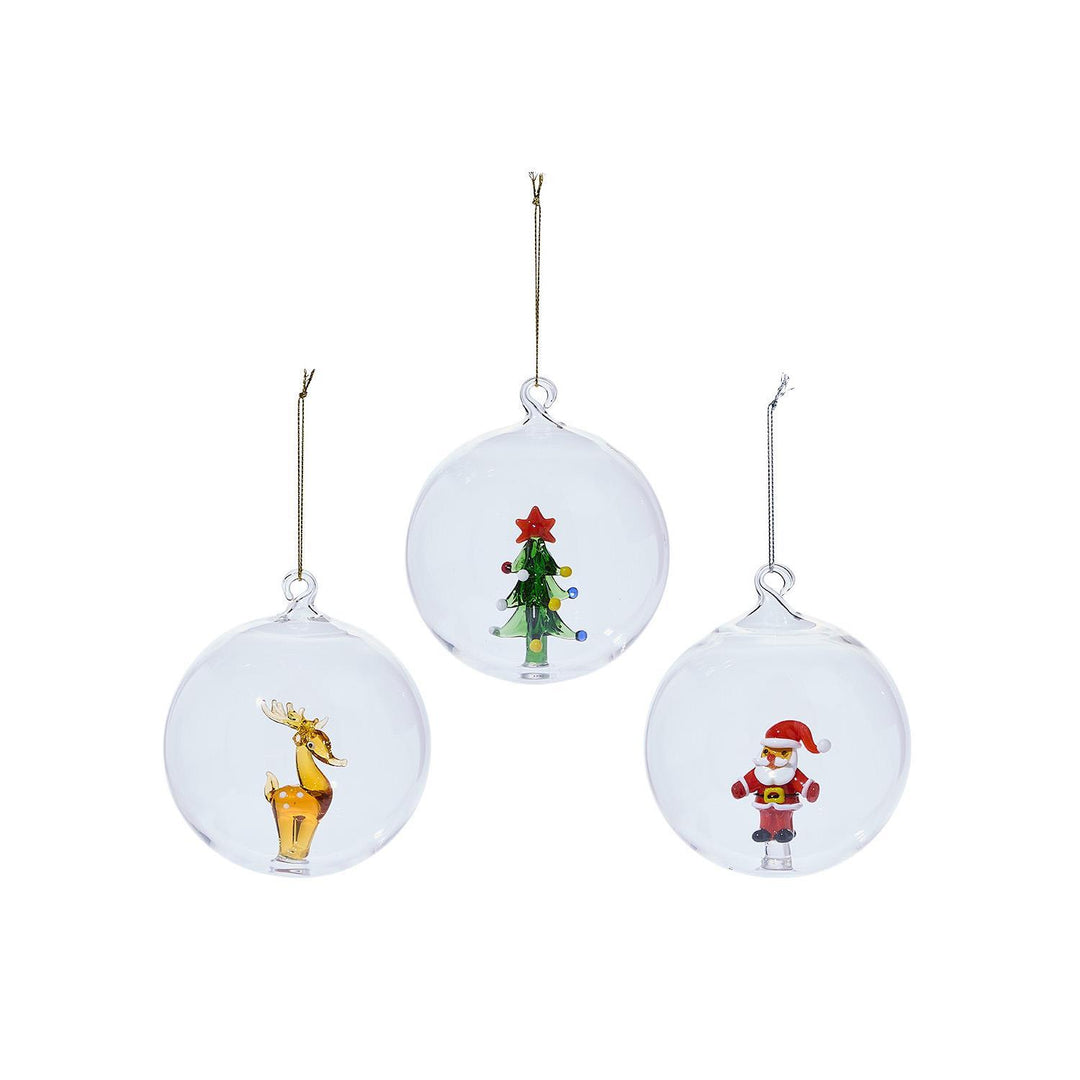 Three clear glass Artisan Ornament globes featuring a reindeer, a Christmas tree, and Santa Claus.
