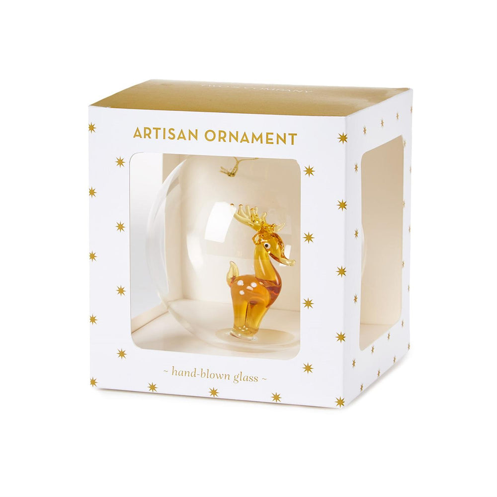 Clear glass ball ornament with an amber-colored glass reindeer inside, packaged in a white and gold star-patterned box.