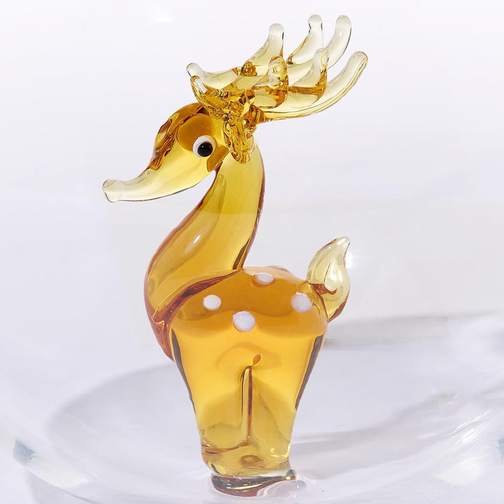 Amber glass deer ornament with white spots and translucent antlers.