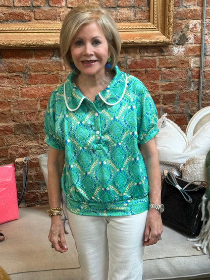 Emerald Bay Top in green, sleeveless and fitted; available in sizes XS-XL. White pants not included.
