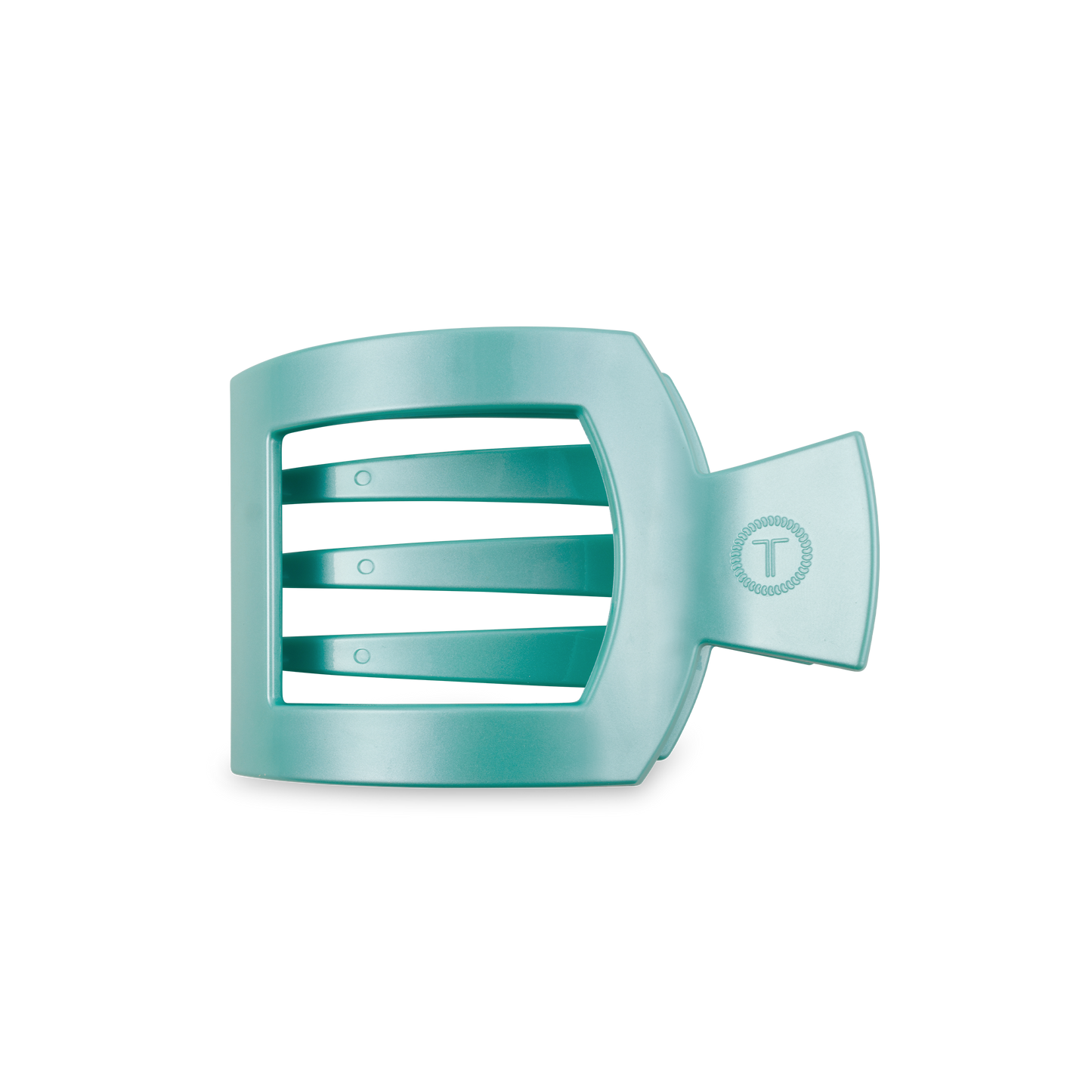 The TELETIES Square Flat Hair Clip in turquoise plastic features a fish-inspired design with three horizontal bars and a fan-like tail. It offers a strong grip and includes a circular logo with a "T" on the right side on a black background. Available sizes: Small, Large.