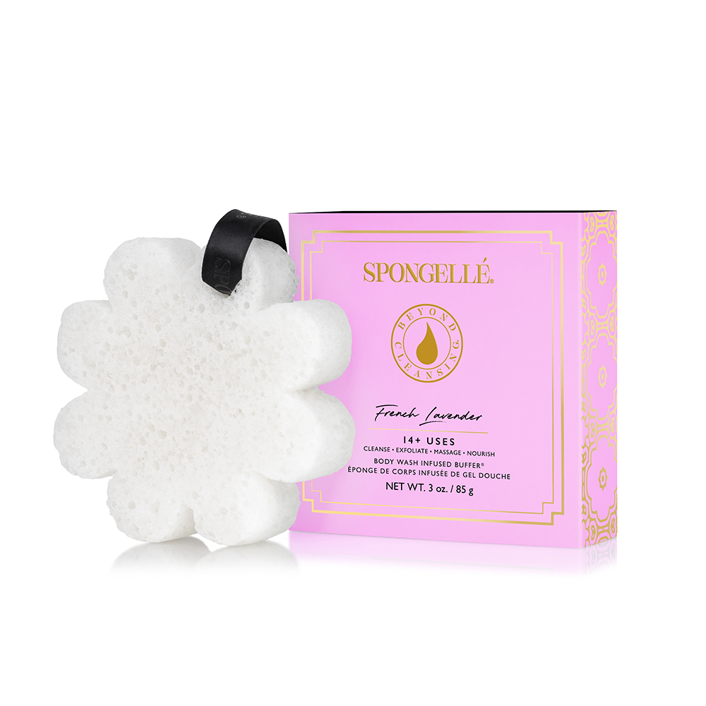 White, flower-shaped bath sponge with black ribbon. Available sizes: standard, large.